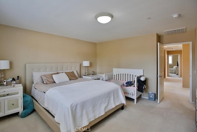 bedroom with visible vents and light colored carpet