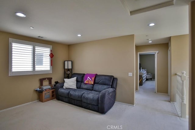 living area featuring recessed lighting, baseboards, light colored carpet, and visible vents