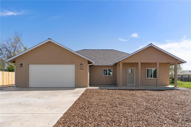 1924 Crandall Way, Paradise, CA 95969 - ranch-style home featuring stucco siding, concrete driveway, a garage, covered porch, and roof with shingles