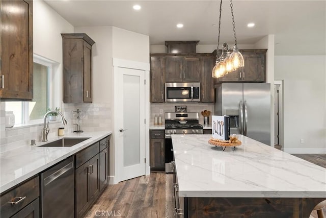 1924 Crandall Way, Paradise, CA 95969 - kitchen with appliances with stainless steel finishes, a sink, dark wood finished floors, dark brown cabinetry, and a kitchen island