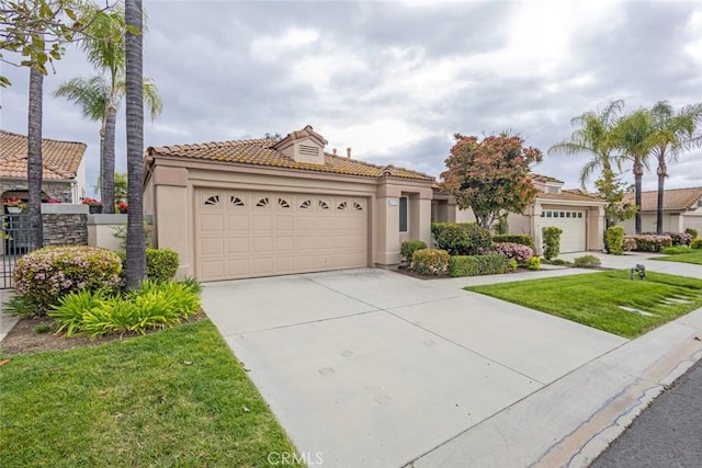 view of front of property featuring driveway, a tile roof, stucco siding, and a garage