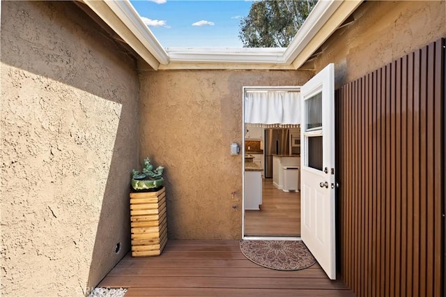view of exterior entry with stucco siding