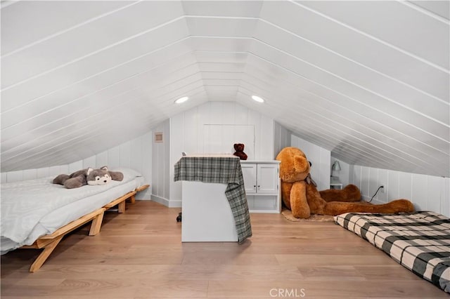bedroom featuring light wood-style floors and lofted ceiling