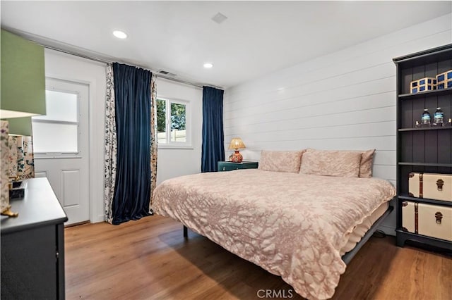 bedroom with wood finished floors and recessed lighting