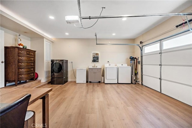 garage with water heater, recessed lighting, a sink, fridge, and washer and clothes dryer