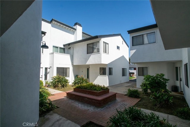 207 Knox St, Costa Mesa, CA 92627 - rear view of property with a patio area, stucco siding, and a chimney