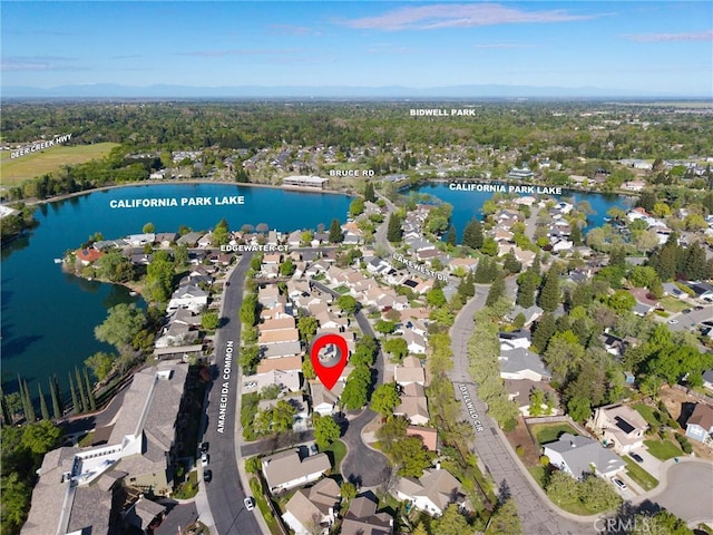 drone / aerial view featuring a water view and a residential view
