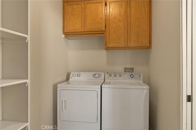 laundry room featuring cabinet space and separate washer and dryer