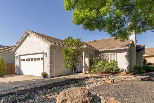ranch-style house with a tiled roof, a garage, fence, concrete driveway, and stucco siding