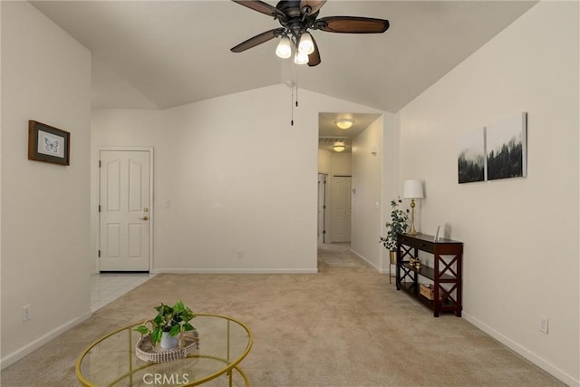 interior space featuring baseboards, light colored carpet, a ceiling fan, and lofted ceiling