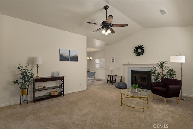living area with baseboards, vaulted ceiling, carpet flooring, a ceiling fan, and visible vents