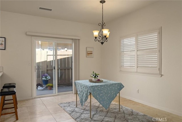 dining area with visible vents, tile patterned floors, a notable chandelier, and baseboards