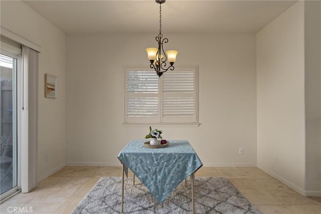 dining space featuring light tile patterned floors, baseboards, and an inviting chandelier