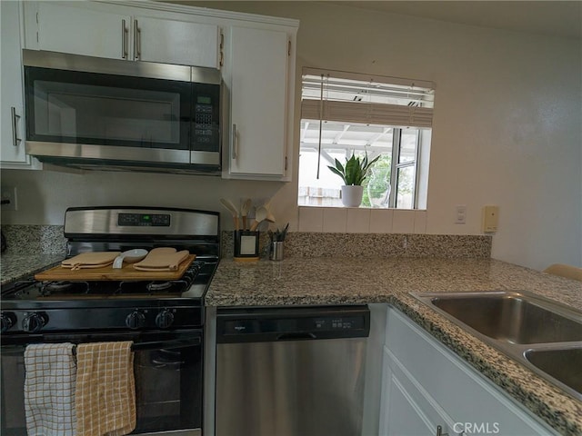 1094 Award Dr, Colton, CA 92324 - kitchen featuring stainless steel appliances, white cabinets, and a sink