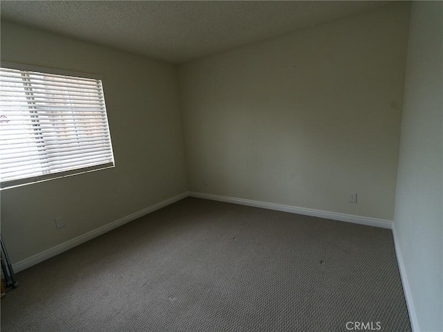 1094 Award Dr, Colton, CA 92324 - carpeted empty room featuring baseboards and a textured ceiling