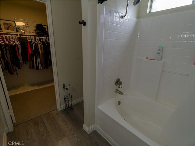 1094 Award Dr, Colton, CA 92324 - bathroom with wood finished floors, a spacious closet, bathtub / shower combination, and baseboards