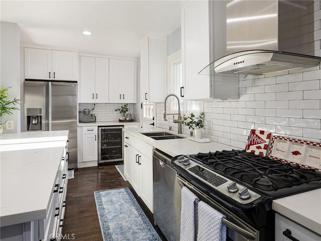 kitchen with range hood, white cabinetry, a sink, stainless steel appliances, and wine cooler