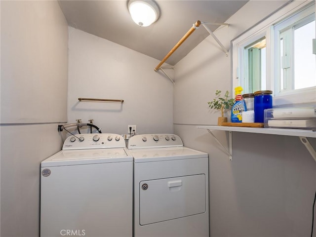 clothes washing area featuring washer and clothes dryer and laundry area