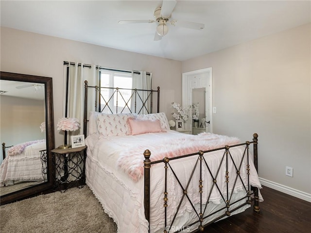 bedroom with ceiling fan, baseboards, and wood finished floors