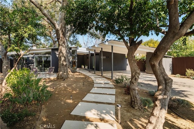 back of property featuring a patio and fence