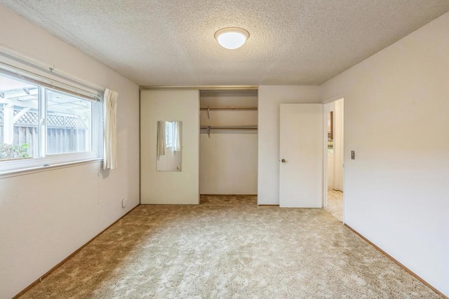 unfurnished bedroom with a closet, carpet, and a textured ceiling