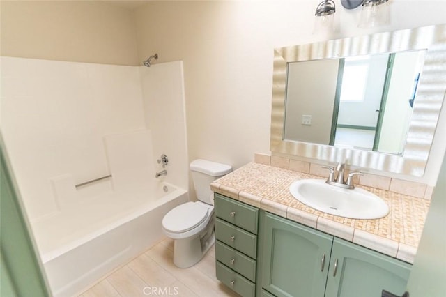 bathroom with vanity, shower / tub combination, and toilet