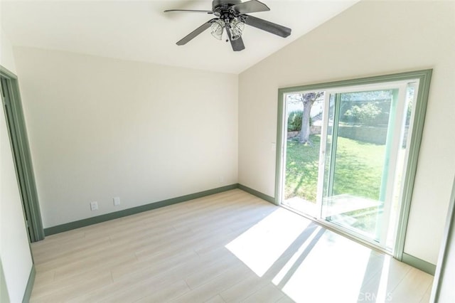spare room featuring a ceiling fan, baseboards, light wood finished floors, and lofted ceiling