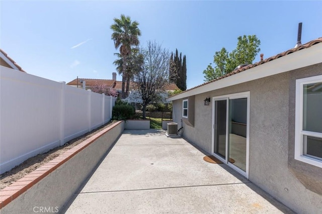 view of patio featuring central AC and a fenced backyard