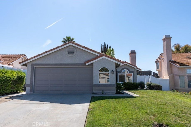 view of front facade with concrete driveway, stucco siding, an attached garage, a front lawn, and fence