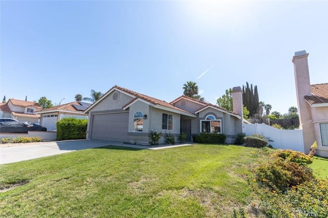 mediterranean / spanish home featuring a garage, fence, stucco siding, a front lawn, and driveway
