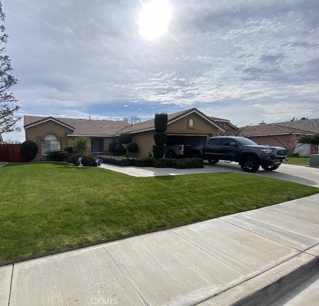 ranch-style home featuring an attached garage, stucco siding, concrete driveway, and a front yard