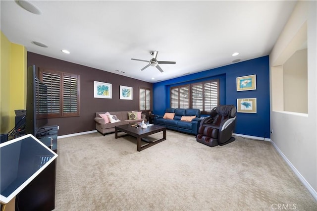 living area featuring visible vents, ceiling fan, carpet, and baseboards