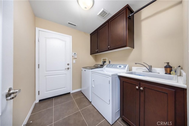 clothes washing area featuring cabinet space, visible vents, independent washer and dryer, and a sink