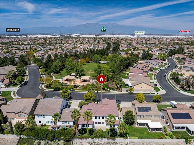 drone / aerial view featuring a residential view and a mountain view