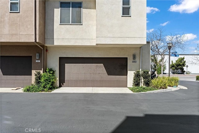 315 Mission Rd, Montebello, CA 90640 - townhome / multi-family property with a garage, stucco siding, and driveway