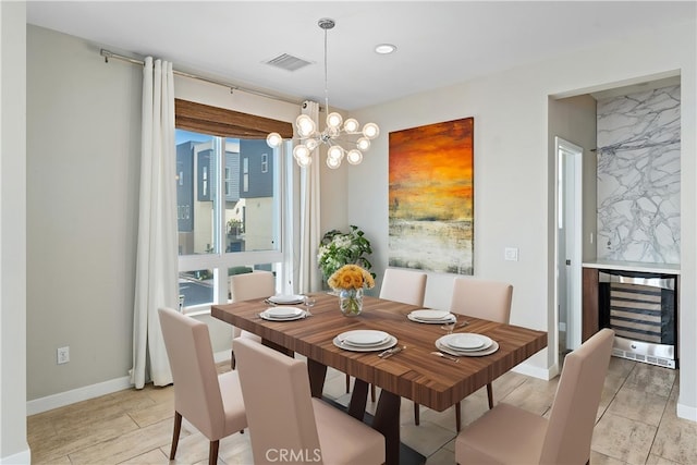 315 Mission Rd, Montebello, CA 90640 - dining space featuring baseboards, a chandelier, light wood-style floors, visible vents, and beverage cooler