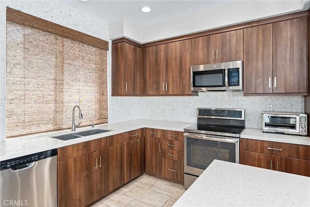 315 Mission Rd, Montebello, CA 90640 - kitchen featuring a toaster, light countertops, a sink, and appliances with stainless steel finishes