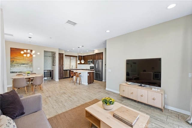 315 Mission Rd, Montebello, CA 90640 - living area with visible vents, recessed lighting, a notable chandelier, and light wood-style floors