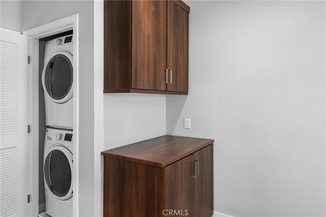 315 Mission Rd, Montebello, CA 90640 - laundry area with baseboards, stacked washer and dryer, and laundry area