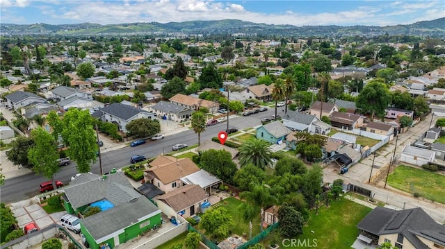755 E 11th St, Pomona, CA 91766 - aerial overview of property's location with mountains and nearby suburban area