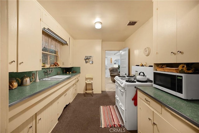755 E 11th St, Pomona, CA 91766 - kitchen with white electric range, dark colored carpet, and dark countertops