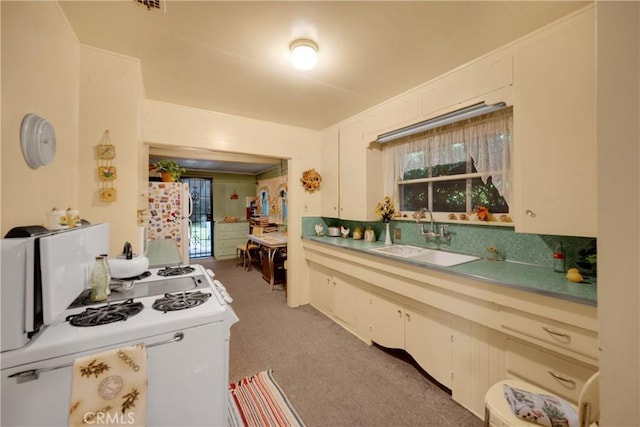 755 E 11th St, Pomona, CA 91766 - kitchen with white appliances, light carpet, light countertops, and plenty of natural light