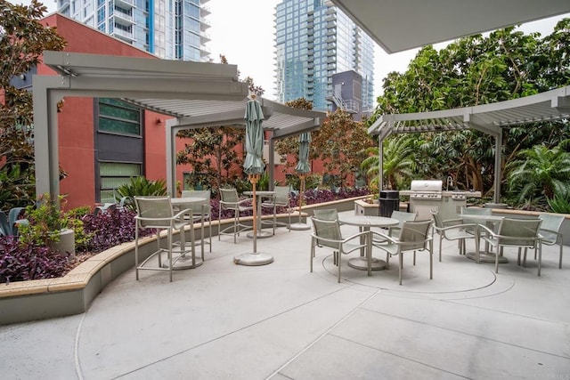 view of patio / terrace with a city view, grilling area, outdoor dining area, and a pergola