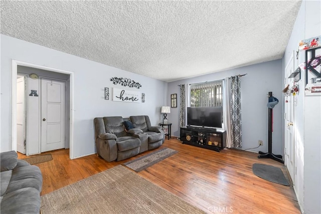 8824 Watson Ave, Whittier, CA 90605 - living area featuring a textured ceiling and wood finished floors