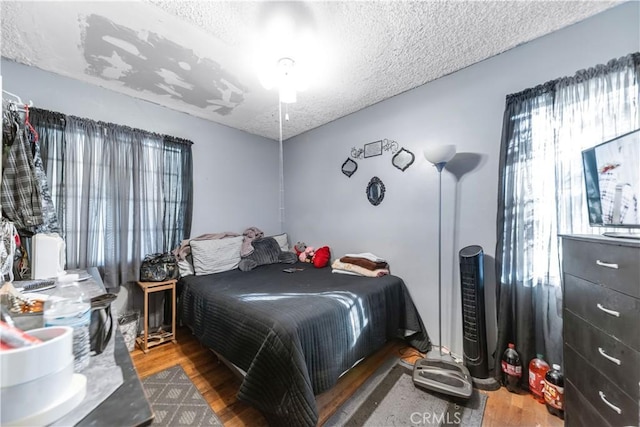8824 Watson Ave, Whittier, CA 90605 - bedroom featuring wood finished floors and a textured ceiling