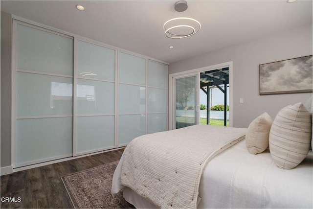 bedroom featuring recessed lighting, access to outside, and wood finished floors