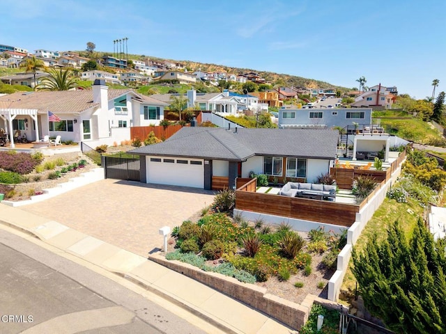 ranch-style home featuring a residential view, driveway, and an attached garage