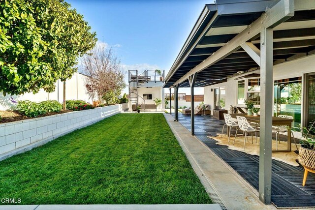 view of yard with a patio and stairs