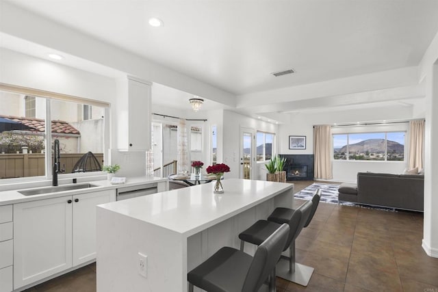 6356 Camino Largo, San Diego, CA 92120 - kitchen featuring a sink, a center island, open floor plan, light countertops, and a kitchen bar