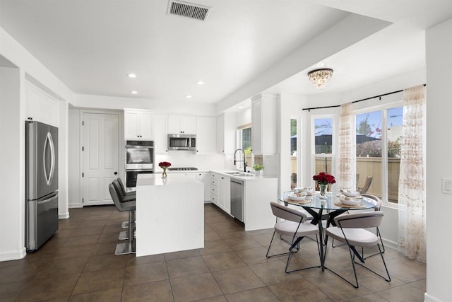6356 Camino Largo, San Diego, CA 92120 - kitchen with stainless steel appliances, a center island, white cabinetry, light countertops, and recessed lighting